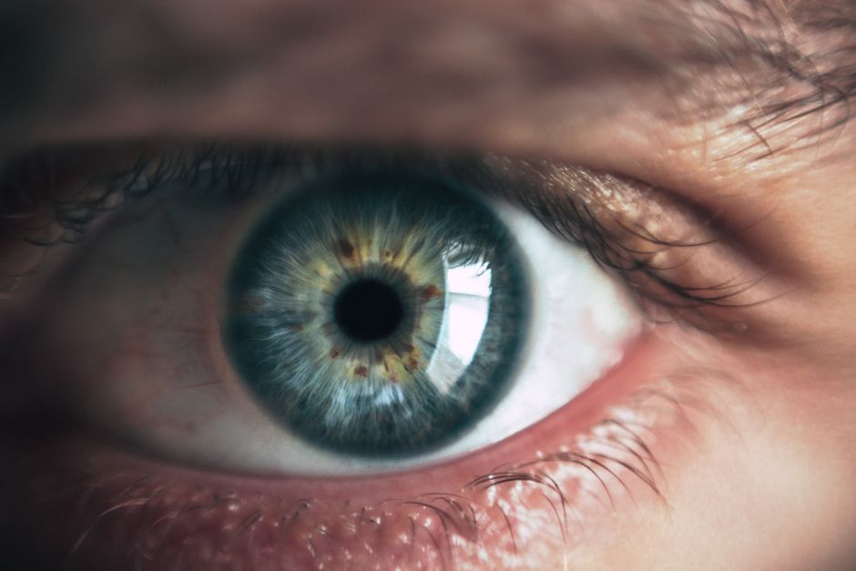 Close-up of a human eye showing a constricted pupil, a common side effect of oxycodone use
