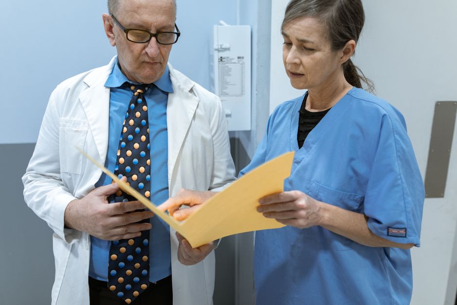 Doctor and patient reviewing an oxycodone medication review checklist during a follow-up appointment