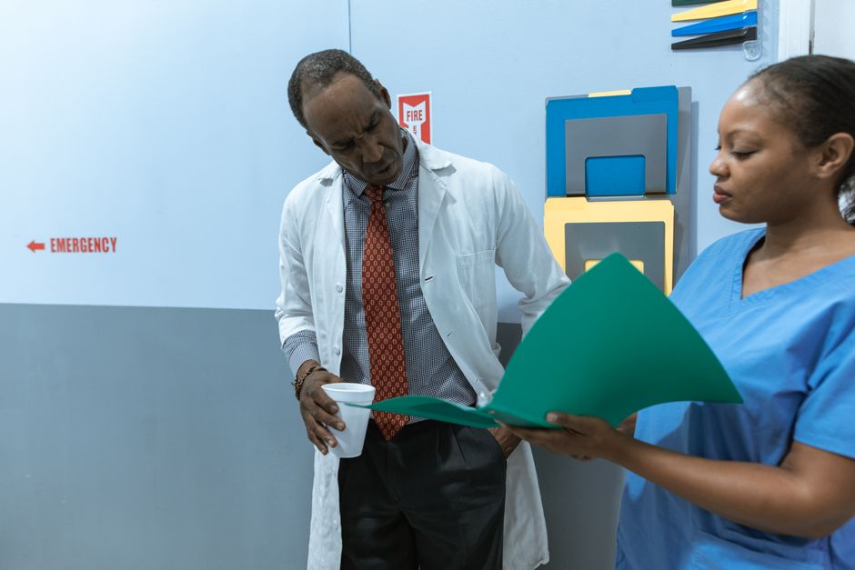 Doctor reviewing patient records during a long-term oxycodone therapy monitoring appointment
