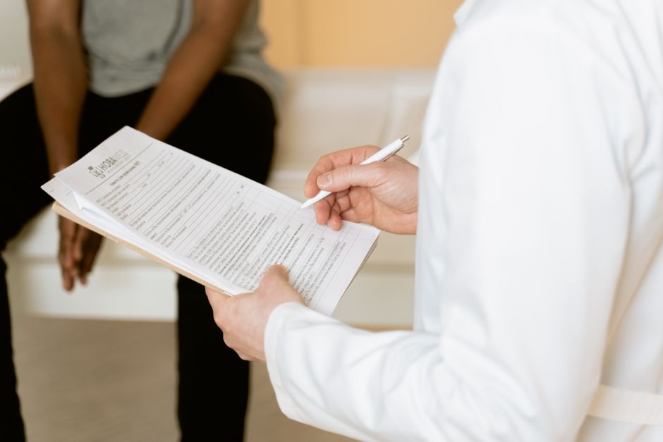 Patient discussing pain symptoms with a doctor during a pain management appointment