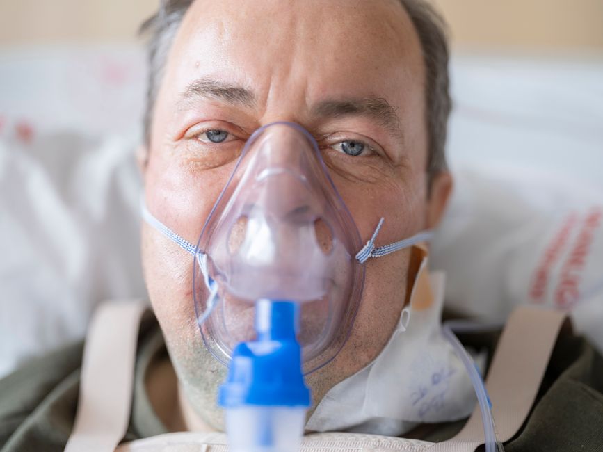 Patient resting in bed during recovery from gallbladder surgery