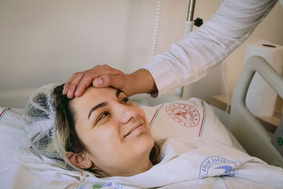 Patient wearing an arm sling during recovery from shoulder surgery, managing pain with oxycodone