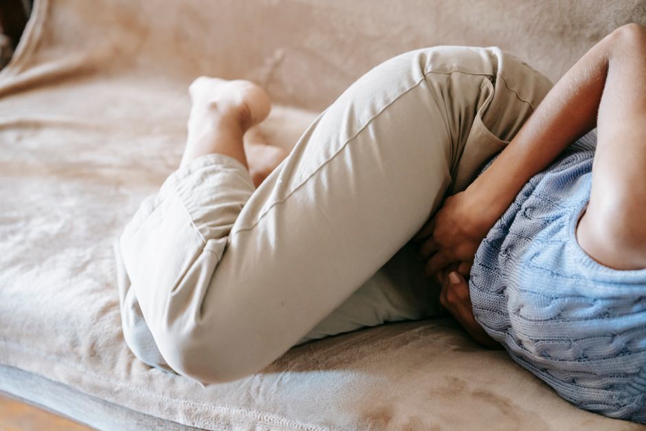 Person holding their back in pain, illustrating a breakthrough pain episode