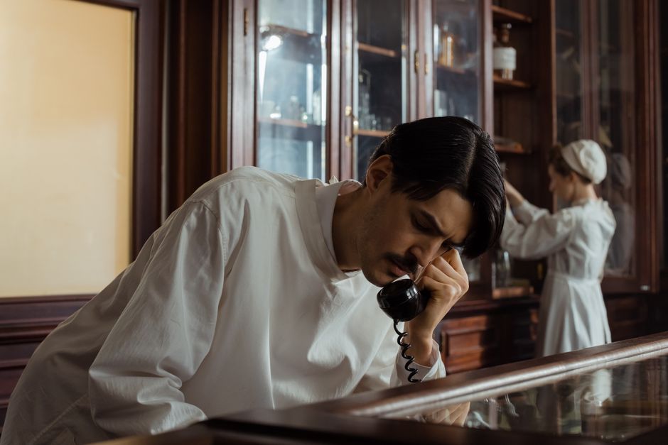 Pharmacist on the phone verifying an oxycodone prescription transfer between pharmacies