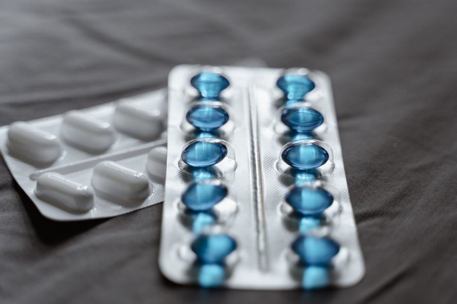 Two types of prescription pain medication pills being compared side by side