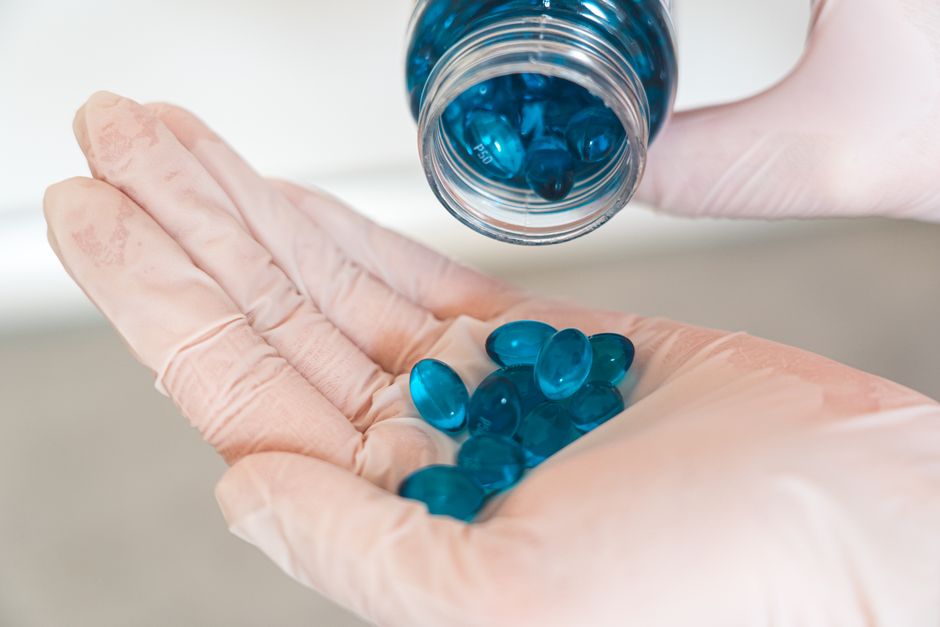 Pharmacist handing over a 30-day supply of oxycodone prescription bottle to a patient